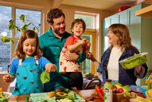 Gotham Greens + Sesame Street collaboration: a family enjoys cooking together in the kitchen